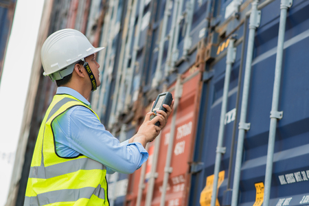 Foreman control loading containers box from cargo freight ship for import export, Foreman control industrial container cargo freight shipの写真素材