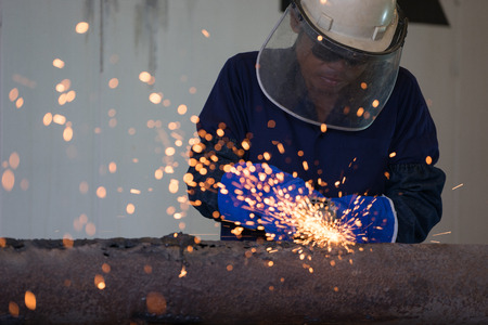 Industrial Worker at the factory welding closeupの写真素材