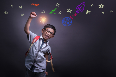 Kid's learning inspiration world in science education with girl child's imagination doodle on teacher's school chalkboard for back to school month and international or universal children's day conceptの写真素材