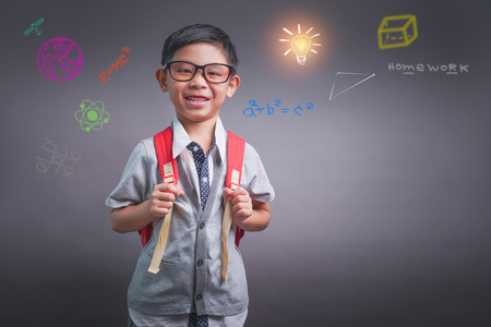 Cheerful smiling little boy with big backpack. Looking at camera. School concept. Back to Schoolの写真素材