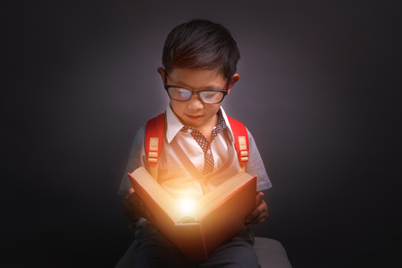 Back to school, Child opened a magic book, Image dark toneの写真素材