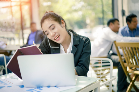 Modern business woman using his laptop in the Cofee Shop. Business Conceptの写真素材