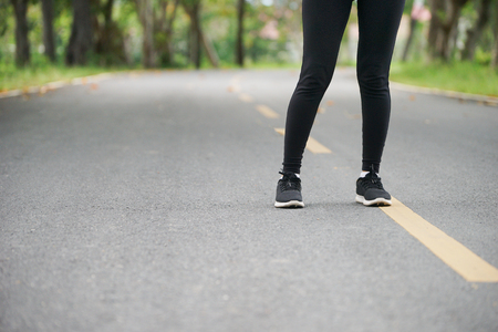 Young fitness sport woman running on the road in the morning, Close up on running shoes, Healthy lifestyle and sport concept, Selective focusの写真素材