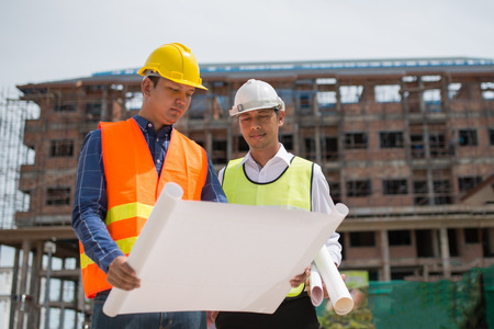 Construction engineers discussion with architects at construction site or building site of highrise buildingの写真素材