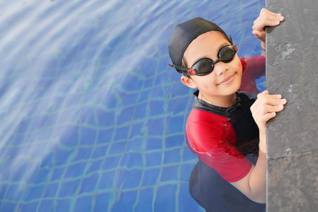 Happy children in the swimming pool. Funny kids playing outdoors. Summer vacation concept