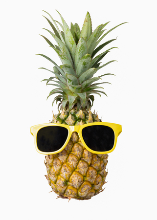 Fashion hipster pineapple, Bright summer color, Tropical fruit with sunglasses, Creative art concept, Minimal style, Hot beach vibes isolated on a white backgroundの写真素材