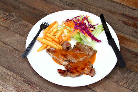 Pork steak on a white plateの写真素材