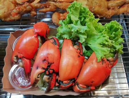 Boiled nippers in a box with dipping sauce and lettuceの写真素材