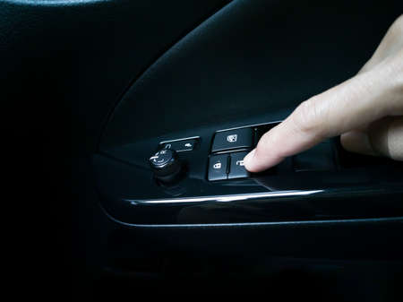 press the inside car door unlock button, black control panel.
