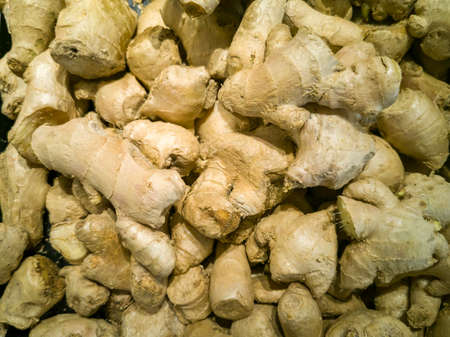 High-angle. Fawn color ginger (Zingiber officinale) stacked in a supermarket, Thailand.