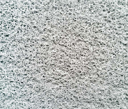 The texture of a gray sponge with a pattern. Background and textureの写真素材