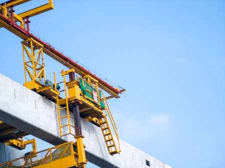Crane and building construction site on blue sky background with copy spaceの写真素材