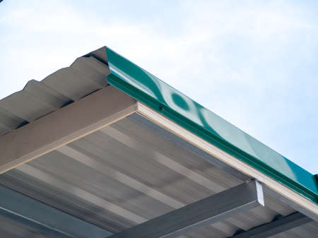 Low angle view, roof eaves corner, metal sheet without ceiling, show rafters, purlin, in Thailand.