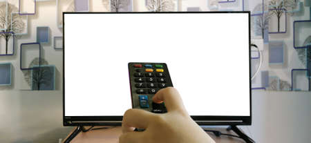 The index finger is pressing the remote control. Behind is a flat screen TV with white space,...