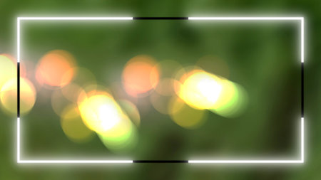 Digital white neon border rectangular shape. Frame sharply defined contrasting. Backdrop blurred green with vibrant bokeh lights shades yellow orange and bright whiteの写真素材