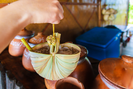 The Health drink on the palm leaf instead the glass.の写真素材