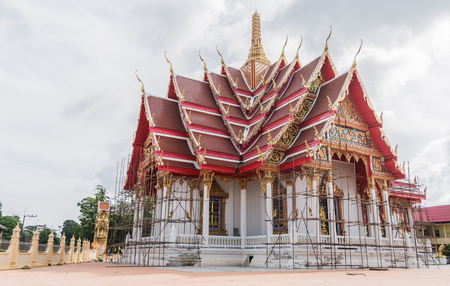 Beautiful temple is being renovated. In the sky with the clouds in the rainy season.の写真素材