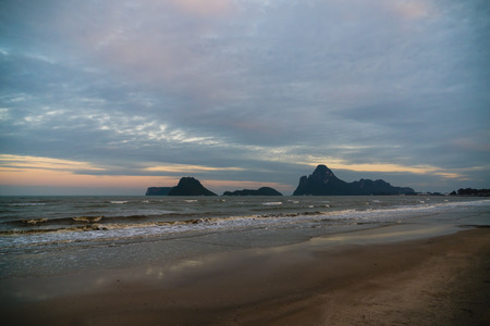 The beautiful seashore is filled with waves under the gray  clouds.の写真素材