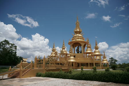 The ancient gold and white pagodas are dominated by the blue sky.の写真素材