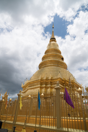 The ancient gold and white pagodas are dominated by the blue sky.の写真素材
