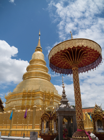 The ancient gold and white pagodas are dominated by the blue sky.の写真素材