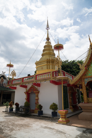 The ancient gold and white pagodas are dominated by the blue sky.の写真素材