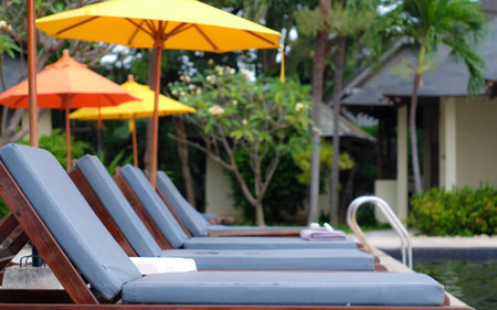 Swimming pool chair yellow Umbrellaの写真素材