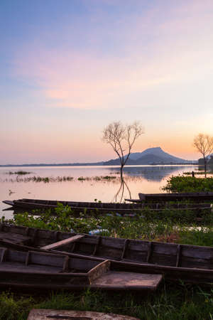 A colorful sunset sky on the waters of Bangpra Lake reservoir の写真素材