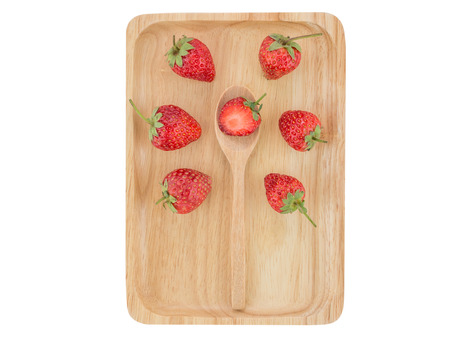 Fresh strawberry on wooden tray, on white backgroundの写真素材