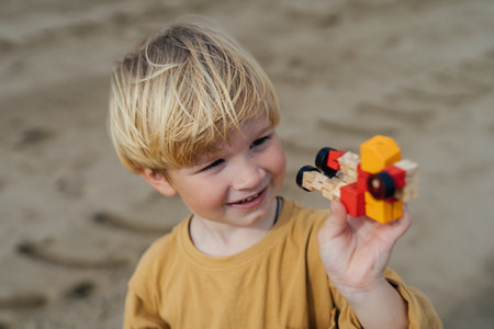 Small Boy Playing with a toy on the beach