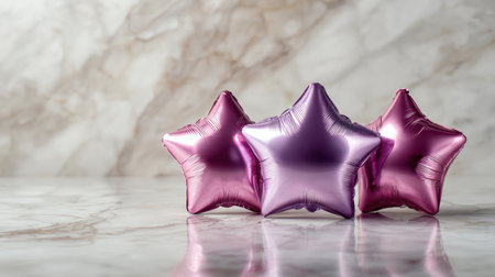 Three colorful star-shaped balloons resting on a smooth marble surface, adding an elegant touch to celebrations, parties, and joyful moments, capturing a sense of fun and festivity.の素材