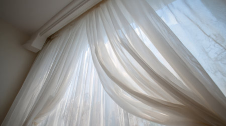 Soft sheer curtains cascade by a window, allowing gentle sunlight to filter through, creating a serene and inviting atmosphere in a bright, tranquil space.の素材