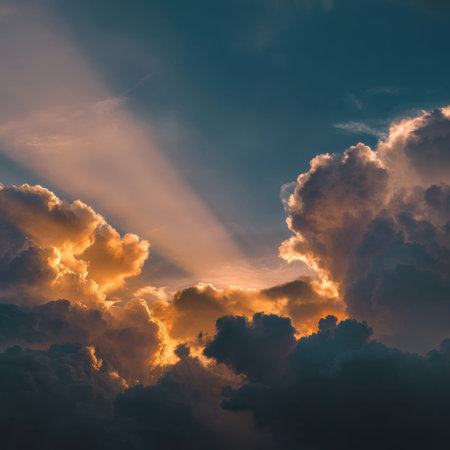 Experience the breathtaking beauty of sunbeams breaking through clouds at sunset, casting a warm golden glow across the natural landscape, creating a serene atmosphere.の素材