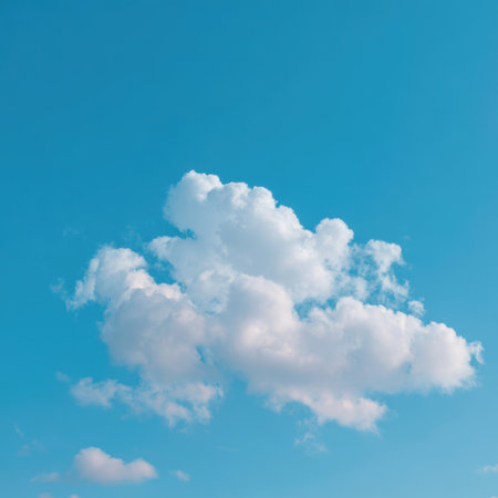A peaceful blue sky filled with soft white clouds under bright daylight creates a tranquil and serene atmosphere, ideal for nature-inspired projects.の素材