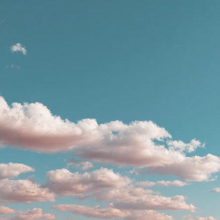 A serene view of soft pastel clouds drifting across a beautiful blue sky, perfect for capturing the essence of tranquility and nature in any creative project or backdrop.の素材