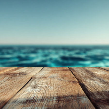 A captivating view of the ocean from a weathered wooden deck, capturing the calmness of the waves and the tranquil sky, perfect for evoking feelings of peace and relaxation.の素材