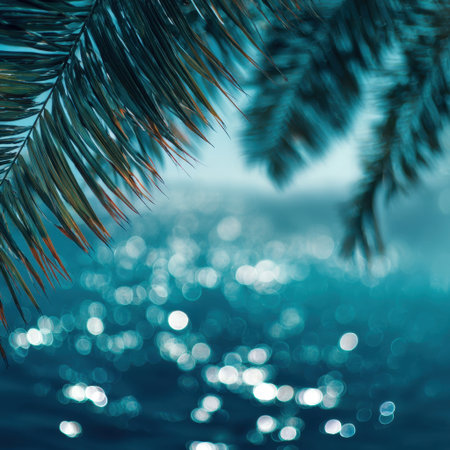 Experience a serene tropical vista featuring sunlit water reflecting through lush palm leaves, evoking feelings of relaxation and natural beauty in a vibrant paradise.の素材