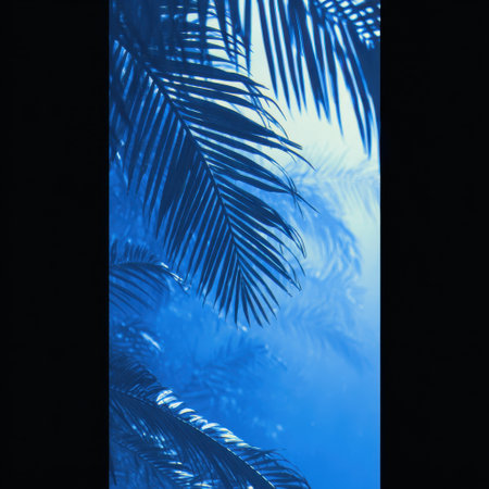 Explore the captivating beauty of lush tropical foliage immersed in cool blue tones, creating a serene backdrop filled with enchanting light and soft shadows. Perfect for nature themes.の素材