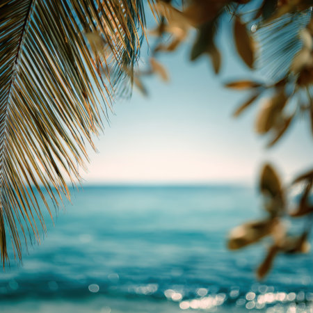 A serene tropical scene featuring lush palm leaves swaying gently in the breeze, overlooking a tranquil ocean horizon and inviting relaxation and escape.の素材