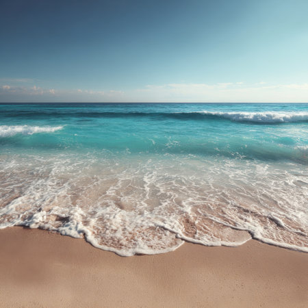 A picturesque view of the shoreline where gentle waves meet soft sand, creating a perfect serene atmosphere for relaxation and enjoyment on a beautiful summer day.の素材