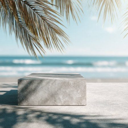 Discover a tranquil beach setting with a smooth stone pedestal surrounded by lush palm leaves and a calm ocean in the background. Perfect for relaxation and inspiration.の素材