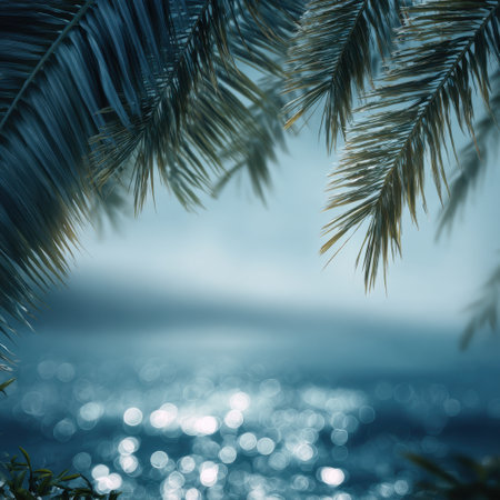 A tranquil coastal scene featuring palm leaves swaying gently over shimmering water, capturing the essence of a relaxing tropical escape in nature's beauty.の素材