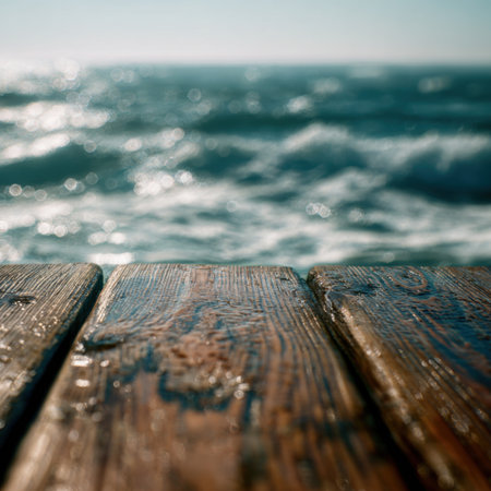 A captivating close-up of a weathered wooden pier with ocean waves shimmering under the bright sunlight, creating a peaceful and serene coastal atmosphere.の素材