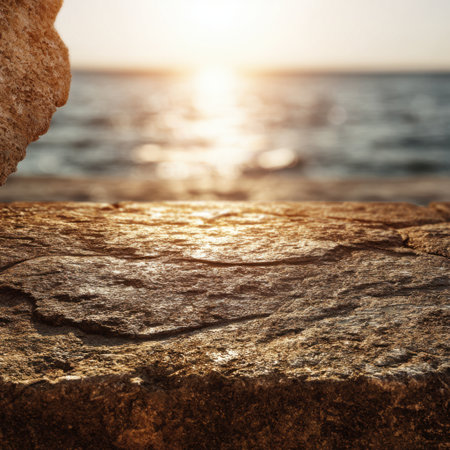 A stunning view showcasing a serene sunset over the ocean, featuring a textured rock formation in the foreground, capturing the essence of natural beauty and tranquility.の素材