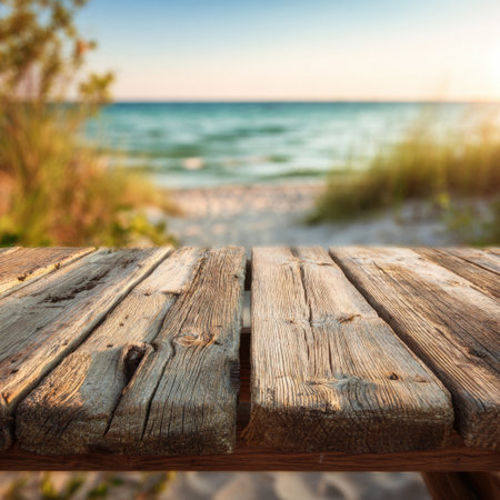 Tranquil beach scene captures a close-up view of weathered wooden planks with a serene ocean backdrop, showcasing the beauty of nature at sunset. Perfect for relaxation themes.の素材