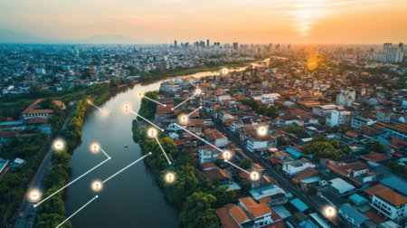 A stunning aerial view of a cityscape at sunset, showcasing a river and homes with connected icons, symbolizing urban connectivity and modern living in a vibrant environment.の素材