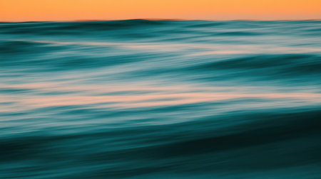 This captivating image showcases the gentle movement of ocean waves beneath a vibrant sunset, creating a serene atmosphere that invites relaxation and reflection.の素材
