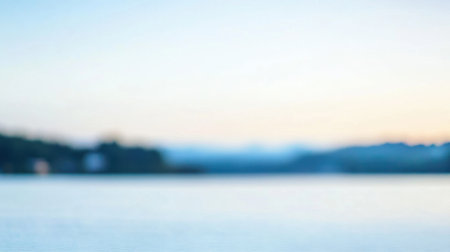 A peaceful water landscape at dawn featuring soft pastel colors and a gentle horizon, perfect for evoking feelings of tranquility and reflection in any setting.の素材