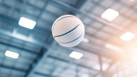 A dynamic image of a basketball captured in mid-air, showcasing the energy of indoor sports with a modern facility background and soft lighting effects.の素材