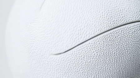 A close-up view capturing the intricate texture and unique patterns of a white sports ball, ideal for themes related to athletics, equipment design, and sports activities.の素材